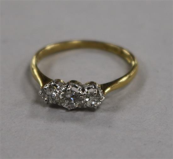 An 18ct gold, platinum and three stone diamond ring, size M/N.